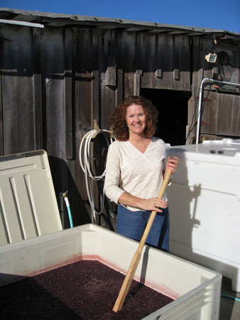 Wendy Nunses punching down the must - St. Rose Winery