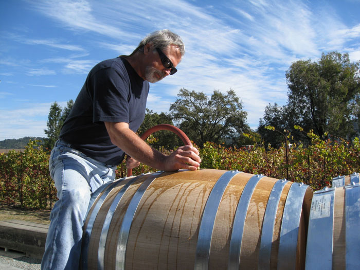 Fred checking the must as it ferments - St. Rose Winery